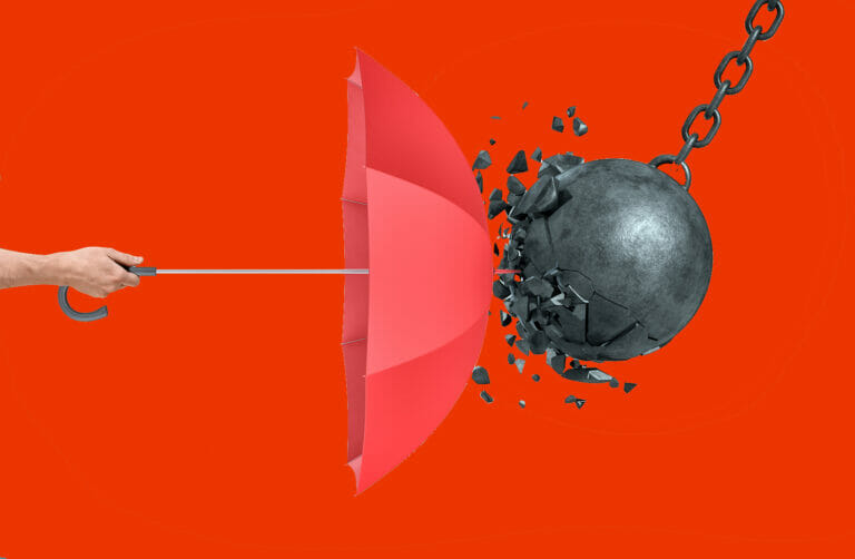 Hand holding an open red umbrella which protects from a collision with a broken wrecking ball - CISO