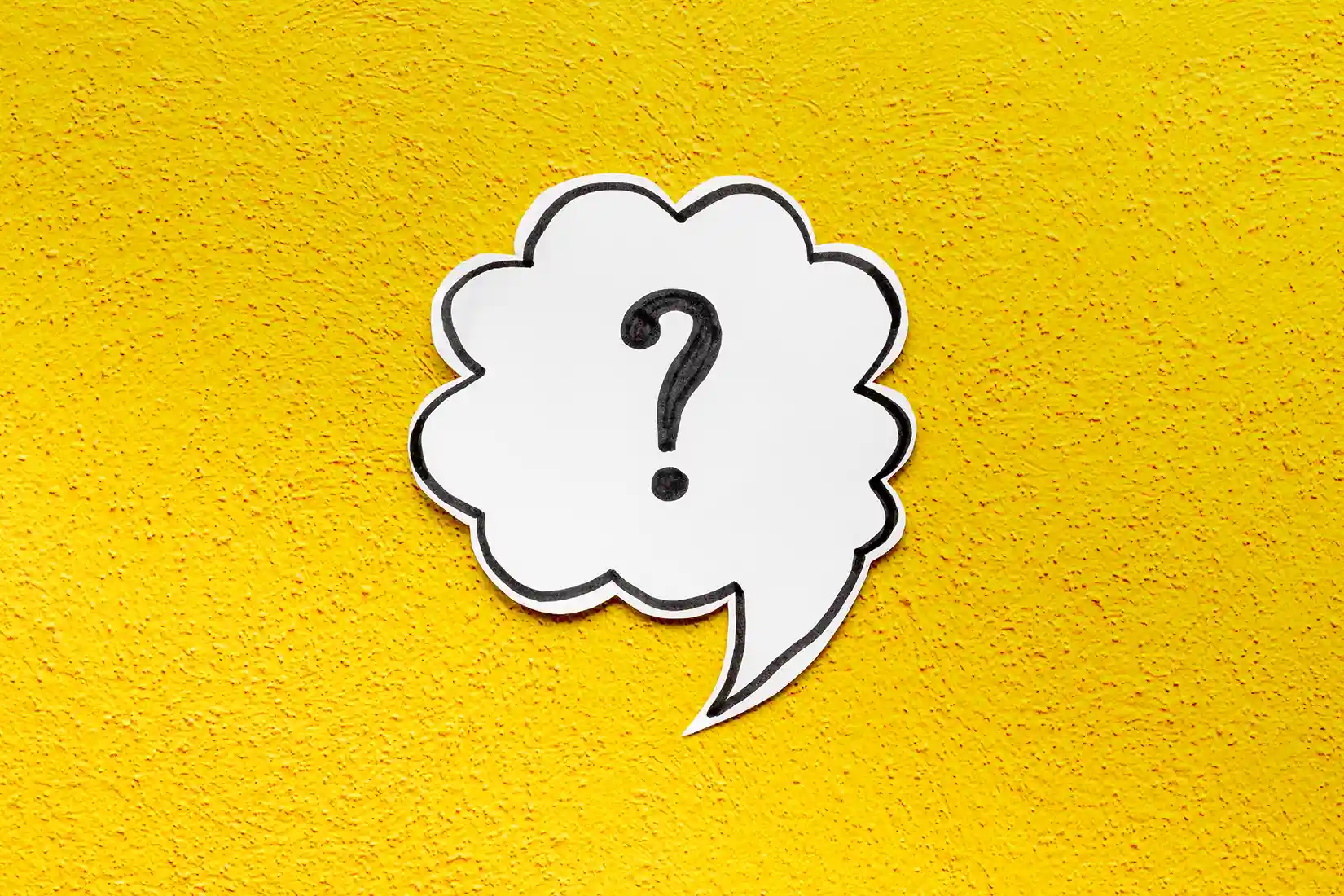 Question mark symbol on speech bubble, top view